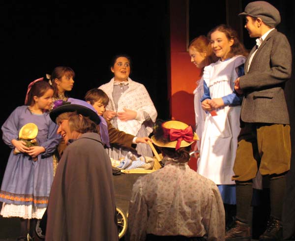 Mrs Perks (Lorna Walpole) and the Perks children (Jessica Haley, Toby Brookes, Lauren Cobb) with members of the chorus and the Railway Children